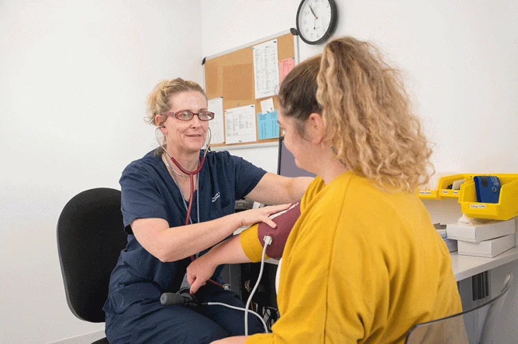 nurse-with-patient-taking-blood-pressure healthcare